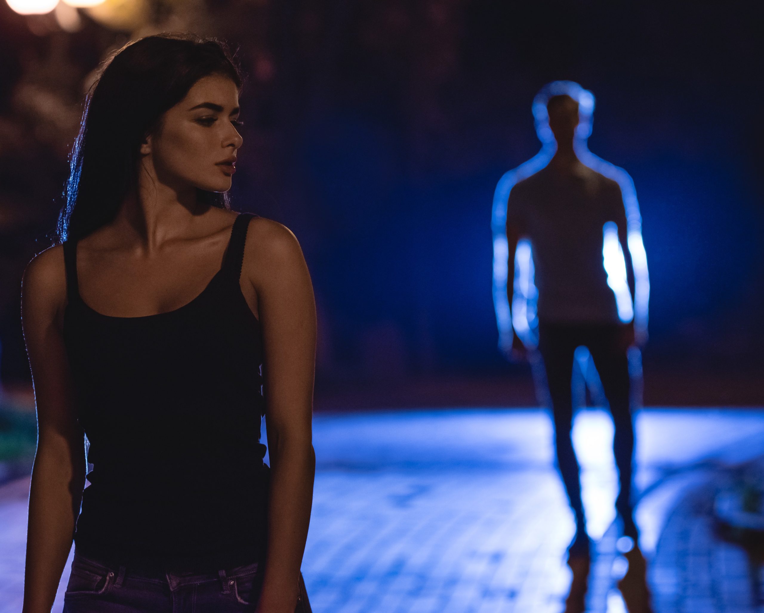 The,Woman,Stand,On,The,Dark,Street,On,The,Background